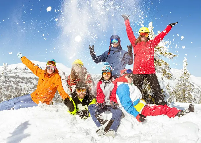 A group celebrating in fresh snow
